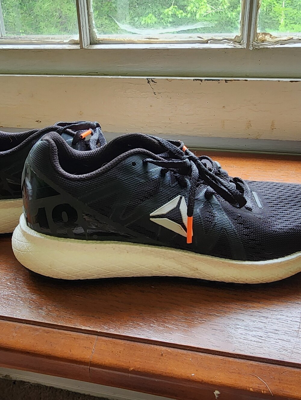 Reebok Women's Size 7 Black Athletic Shoes with White Midsole and Orange Accent